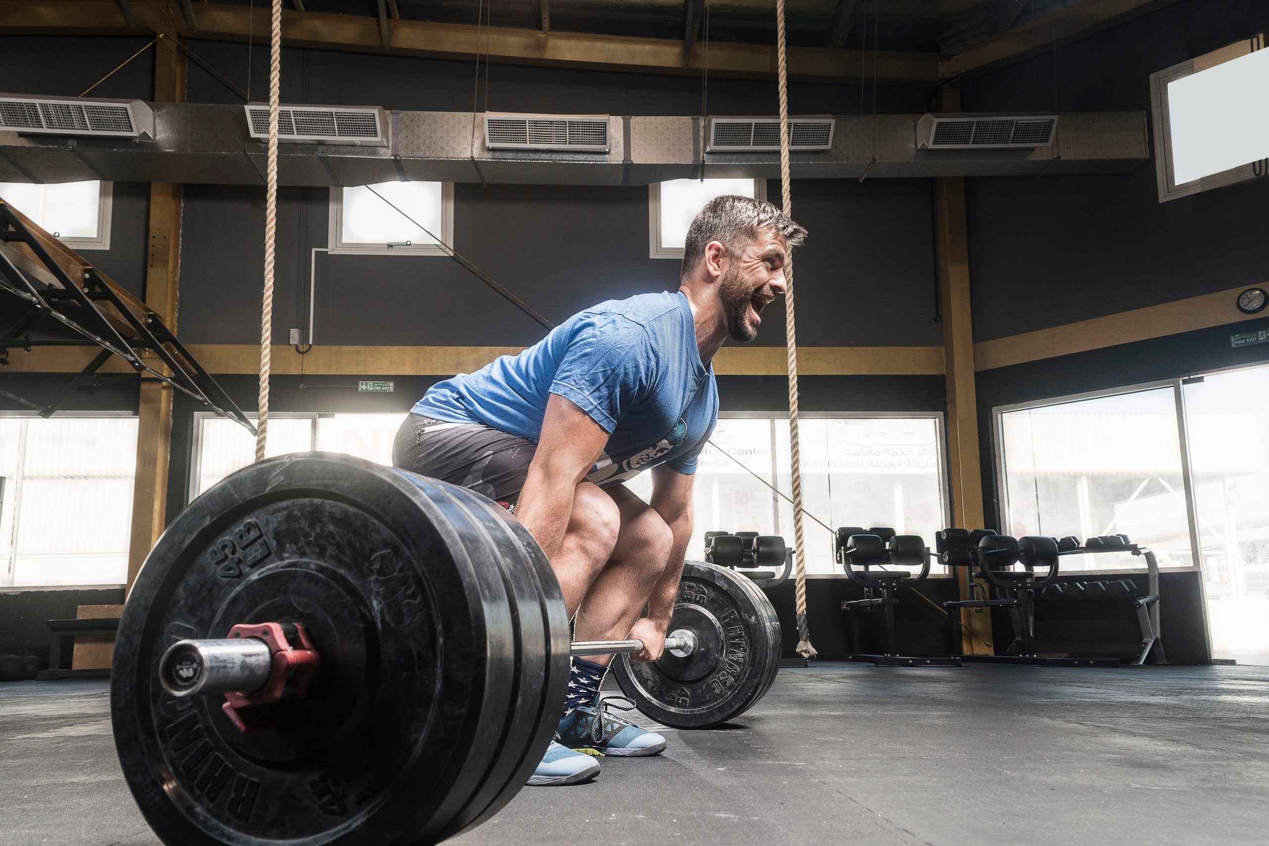 Man lifting weights with olympic barbell