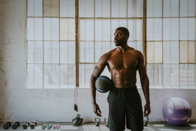 Guy holding a medicine ball at the gym